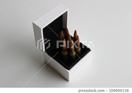 Seven bullets in a white box with black trim lined up like in a revolver drum on white background  109000136