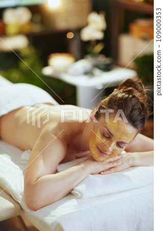 relaxed modern woman in massage cabinet laying on massage table relaxed modern woman in massage cabinet laying on massage table 109000353