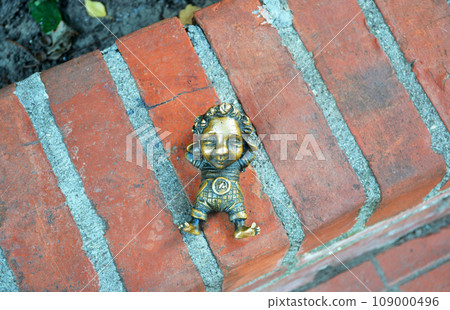 Kaliningrad, Russia, bronze statuette of homlin baby Antoshka, local landmark, city brownie Kaliningrad, Russia, bronze statuette of homlin baby Antoshka, local landmark, city brownie 109000496