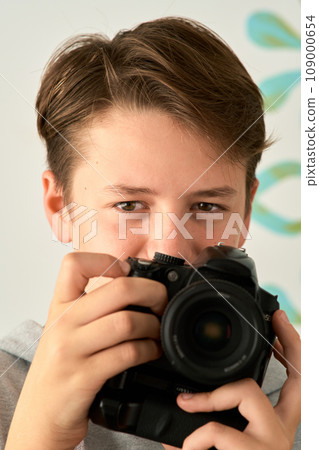 a boy with camera in his hands a boy with camera in his hands 109000654