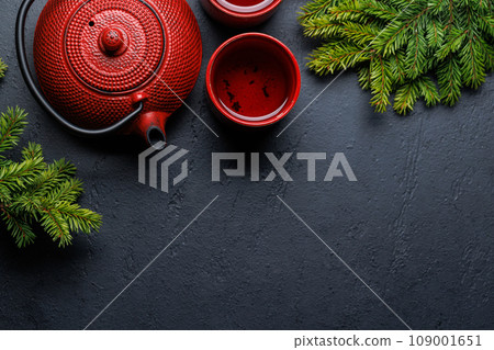 Teapot, cup, and fir tree branches create a cozy scene Teapot, cup, and fir tree branches create a cozy scene 109001651
