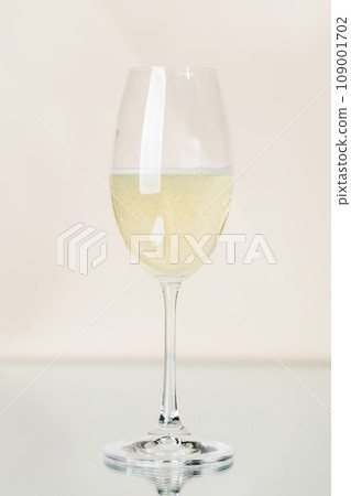 Champagne glass on a beige Champagne glass on a beige 109001702