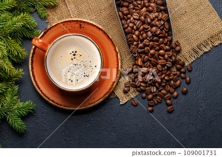 Coffee cup and fir tree branches in cozy setting Coffee cup and fir tree branches in cozy setting 109001731