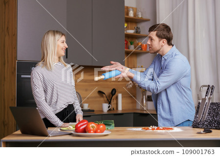 Leave Me Alone. A woman is preparing food, and a man is talking to her, and is not satisfied with the way she is cooking. Leave Me Alone. A woman is preparing food, and a man is talking to her, and is not satisfied with the way she is cooking. 109001763