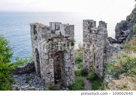 Ruins of ancient buildings on coast of Antalya. Ancient buildings by the sea. 109002640