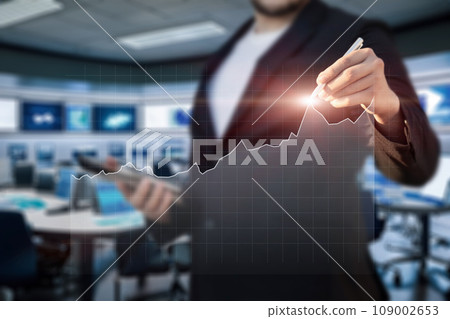 A manager analyzes a financial chart on a virtual screen . A manager analyzes a financial chart on a virtual screen . 109002653
