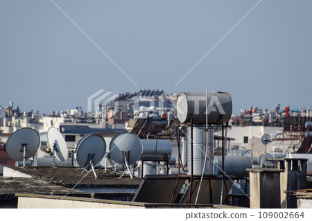 Steel barrels of boilers with water on the roof of a building to heat water 109002664