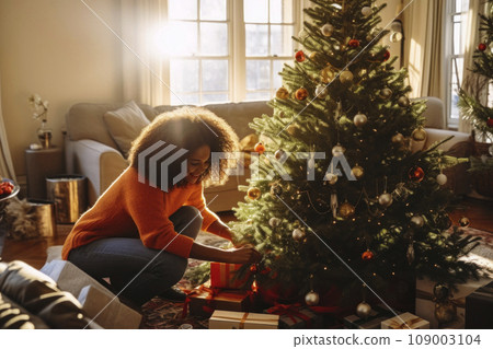 African American mom and daughter decorate a Christmas tree together African American mom and daughter decorate a Christmas tree together 109003104