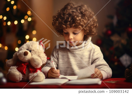 Cute little boy with curly hair writes the letter to Santa Claus Cute little boy with curly hair writes the letter to Santa Claus 109003142