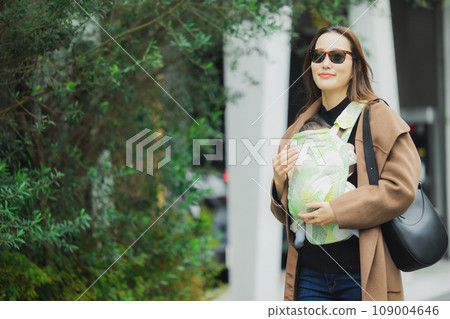 A mother goes out with her baby in a baby carrier 109004646