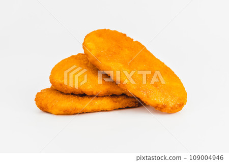 Chicken Breaded Fillet. Breaded chicken nuggets. Fast homemade food at home. Chicken breaded schnitzels. Breaded Chicken Inner Fillet on a White Background,Chicken Breaded Raw Meat. Fast cooking. 109004946