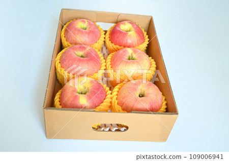 beautiful pink apple in the box on blue background 109006941
