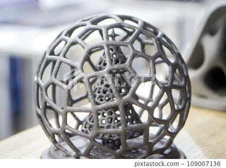 Abstract model Christmas tree in mesh ball printed on 3D printer from polyamide powder close-up. Technology Multi Jet Fusion, MJF. Three-dimensional model created on 3D printer from powder plastic 109007136
