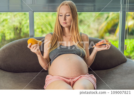 A pregnant woman faces a choice between nourishing, wholesome food and tempting fast food, highlighting the importance of healthy dietary decisions during pregnancy A pregnant woman faces a choice between nourishing, wholesome food and tempting fast food, highlighting the importance of healthy dietary decisions during pregnancy 109007821