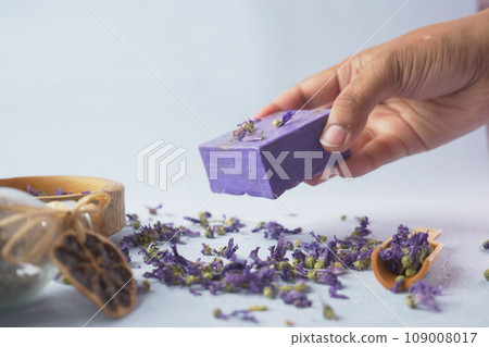 hand pick Homemade natural soap bar and lavender flower on table  109008017