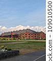 Red brick warehouse, blue sky and white clouds 109010500
