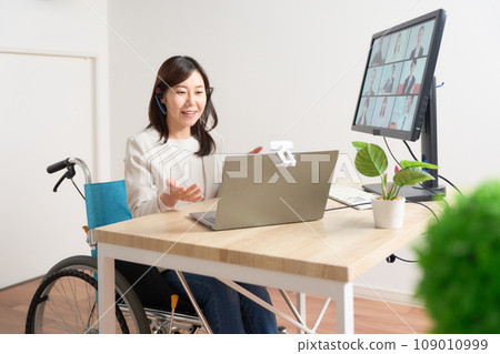 Woman in a wheelchair having a video call Woman in a wheelchair having a video call 109010999