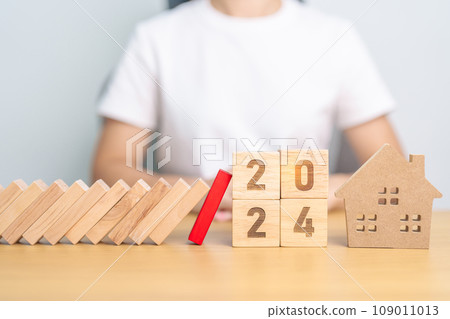 falling blocks with 2024 Year protect house miniature. Inflation financial, Home Insurance, investment, Crisis, Economic recession, New Year, Real Estate and Property concept falling blocks with 2024 Year protect house miniature. Inflation financial, Home Insurance, investment, Crisis, Economic recession, New Year, Real Estate and Property concept 109011013