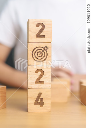 2024 block with dartboard sign. Business Goal, Target, Resolution, strategy, plan, Action motivation, mission, thinking, and New Year start concepts 109011020