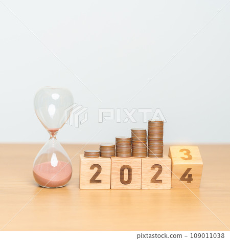 Happy New Year with sandglass and flipping 2023 change to 2024 block. Resolution, Goals, Plan, Action, Money Saving, Retirement fund, Pension, Investment and Financial concept 109011038