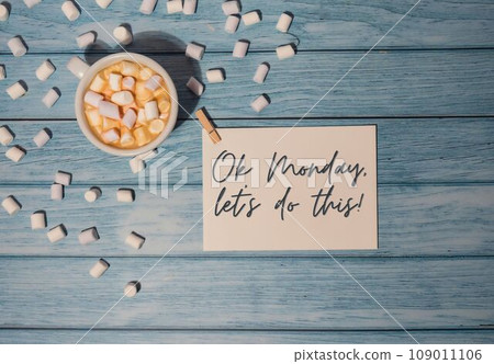 OK MONDAY LET'S DO THIS concept text paper note with white cup of coffee and marshmallows on wooden background. The most depressing day of the year in January. Day commit suicide and depression 109011106