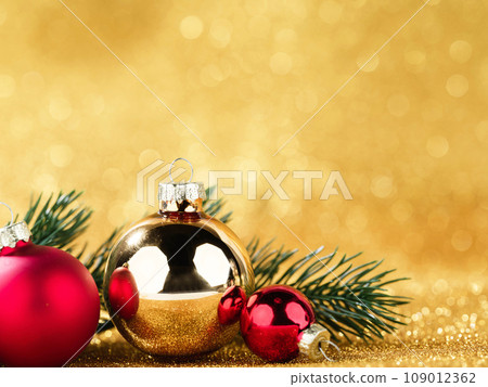 red and gold balls and fir on bokeh background 109012362