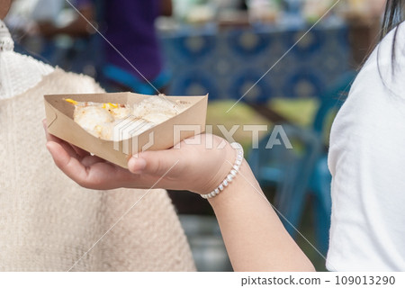 Thai Pancake, Women hands holding khanom krok Traditional Thai desserts with delicious Thai Pancake, Women hands holding khanom krok Traditional Thai desserts with delicious 109013290