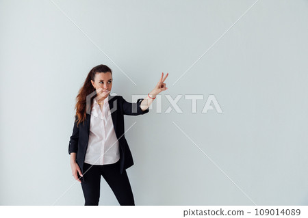 Beautiful business woman showing two fingers of her hand Beautiful business woman showing two fingers of her hand 109014089