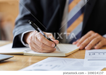 Hands of an Asian businessman studying Hands of an Asian businessman studying 109014137