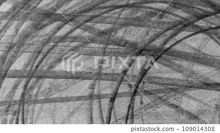 Aerial view tire track mark on asphalt tarmac road race track texture and background, Abstract background black tire track skid on asphalt road, Tire mark skid mark on asphalt road. Aerial view tire track mark on asphalt tarmac road race track texture and background, Abstract background black tire track skid on asphalt road, Tire mark skid mark on asphalt road. 109014308