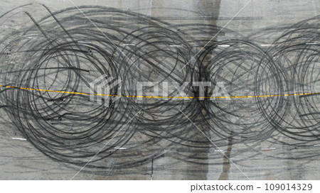 Aerial view tire track mark on asphalt tarmac road race track texture and background, Abstract background black tire track skid on asphalt road, Tire mark skid mark on asphalt road. Aerial view tire track mark on asphalt tarmac road race track texture and background, Abstract background black tire track skid on asphalt road, Tire mark skid mark on asphalt road. 109014329