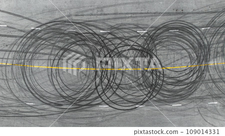 Aerial view tire track mark on asphalt tarmac road race track texture and background, Abstract background black tire track skid on asphalt road, Tire mark skid mark on asphalt road. Aerial view tire track mark on asphalt tarmac road race track texture and background, Abstract background black tire track skid on asphalt road, Tire mark skid mark on asphalt road. 109014331
