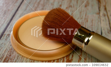 The powder brush lies next to the box with the compact powder. Makeup, beauty and care concept 109014632