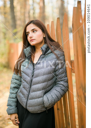 Close up portrait of pretty indian young woman enjoying warm autumn sunny day vacation outdoors. Generation z and gen z concept. Fall Season Close up portrait of pretty indian young woman enjoying warm autumn sunny day vacation outdoors. Generation z and gen z concept. Fall Season 109014641