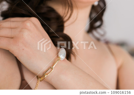 Close-up woman wearing beautiful luxury bracelets. Handmade jewellery and accessories 109016156