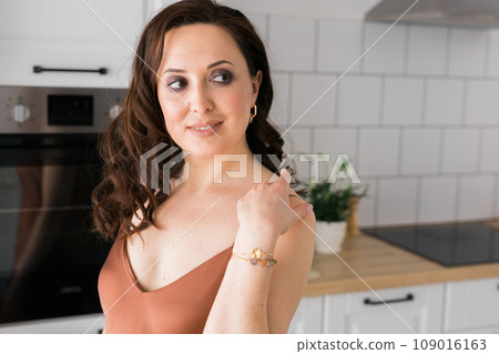 Close-up woman wearing beautiful luxury bracelets. Handmade jewellery and accessories 109016163