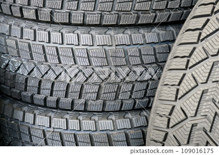 Close-up of the tread pattern of a new friction winter tire for snow and ice Close-up of the tread pattern of a new friction winter tire for snow and ice 109016175