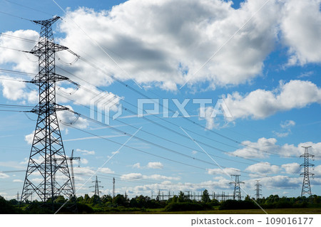 An industrial nature landscape with many high voltage power lines transmission pylons An industrial nature landscape with many high voltage power lines transmission pylons 109016177
