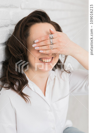 Women Jewelry concept. Woman's hands close up wearing rings and necklace modern accessories elegant lifestyle. Funny girl Women Jewelry concept. Woman's hands close up wearing rings and necklace modern accessories elegant lifestyle. Funny girl 109016215