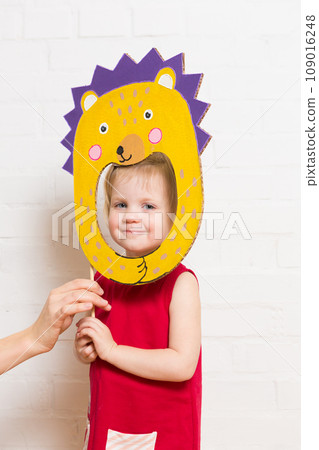 Little girls holding hedgehog mask on white background 109016248