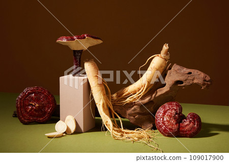 Minimal art background with fresh ginseng roots and ganoderma mushrooms decorated on brown background. Photo for medicine advertising, photography traditional medicine content Minimal art background with fresh ginseng roots and ganoderma mushrooms decorated on brown background. Photo for medicine advertising, photography traditional medicine content 109017900