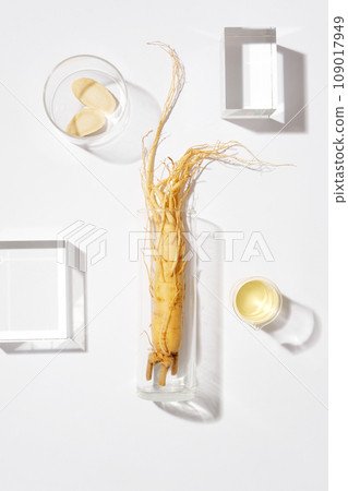Minimal scene for advertising and branding product with herbal ingredient from korean. A fresh ginseng on glass vase decorated with some glass podiums on white background Minimal scene for advertising and branding product with herbal ingredient from korean. A fresh ginseng on glass vase decorated with some glass podiums on white background 109017949