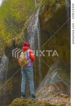 Travel. The girl travels through the mountains and waterfalls of the wild. Unity, mental health, eco-travel. Hiking, traveling, good times, digital detox. 109018304