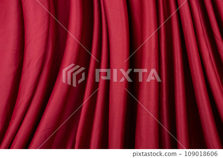 Texture, background, template. Silk fabric. Red silk drapery and upholstery fabric. Solid fabrics for backdrop, drapes, flags and curtains 109018606