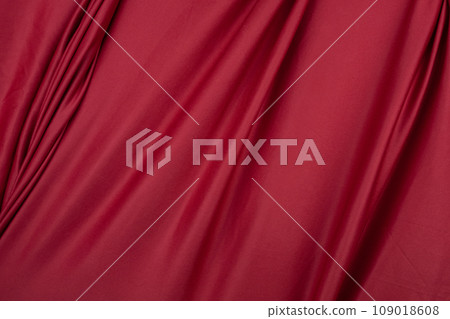 Texture, background, template. Silk fabric. Red silk drapery and upholstery fabric. Solid fabrics for backdrop, drapes, flags and curtains 109018608