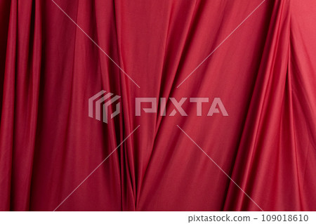Texture, background, template. Silk fabric. Red silk drapery and upholstery fabric. Solid fabrics for backdrop, drapes, flags and curtains 109018610