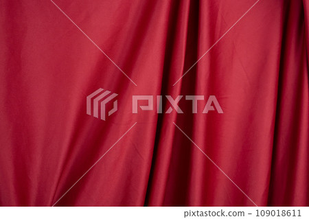 Texture, background, template. Silk fabric. Red silk drapery and upholstery fabric. Solid fabrics for backdrop, drapes, flags and curtains 109018611