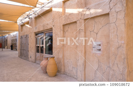 Narrow streets that create shade on a hot day in the old city of Dubai Creek and Bur district. Travel destinations and heritage village 109018672