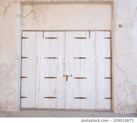 Arabic style carved wooden doors in Al Fahidi Historical District, Deira, Dubai, United Arab Emirates. Arabic style carved wooden doors in Al Fahidi Historical District, Deira, Dubai, United Arab Emirates. 109018675