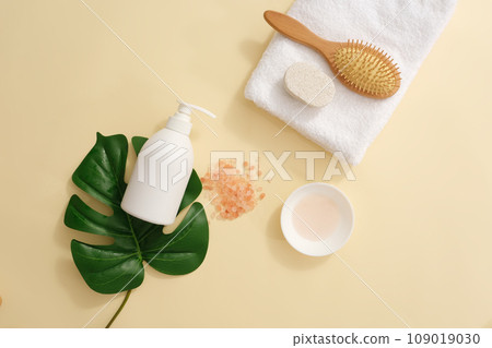White pump bottle without label placed on a green leaf. A folded towel featured a hairbrush and foot scrubber brush. Blank label for natural beauty product promotion White pump bottle without label placed on a green leaf. A folded towel featured a hairbrush and foot scrubber brush. Blank label for natural beauty product promotion 109019030